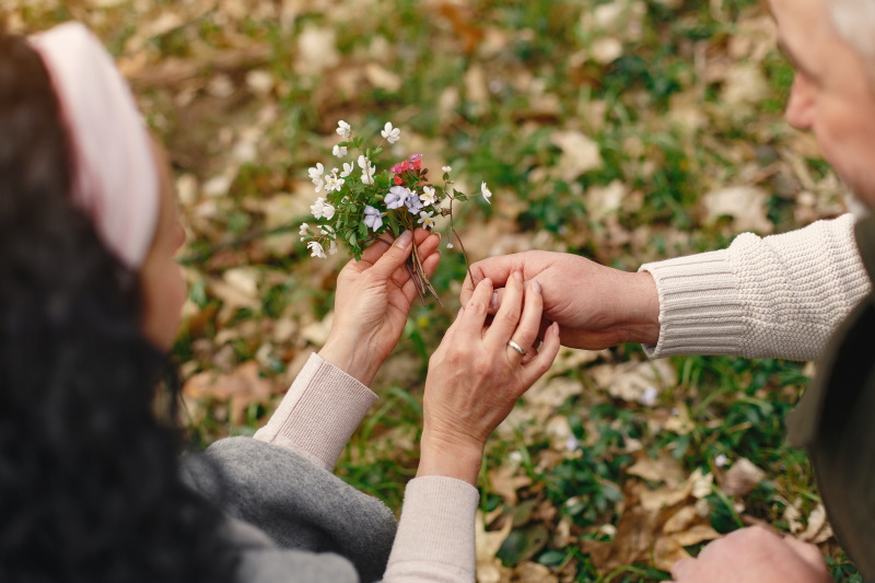Resident and staff member collecting wild flowers