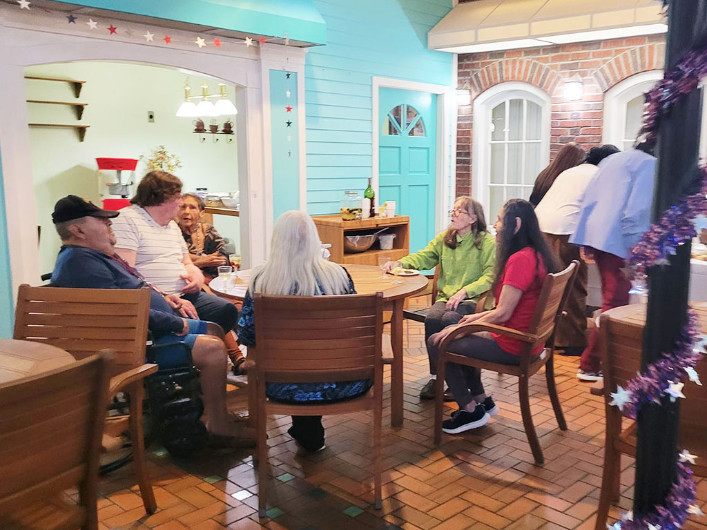 Residents and guests talking and eating together